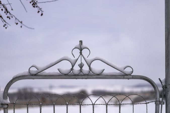 Snow resting on an ornamental gate