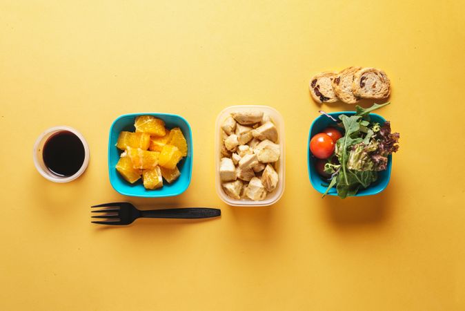 Plastic containers with healthy food and fork