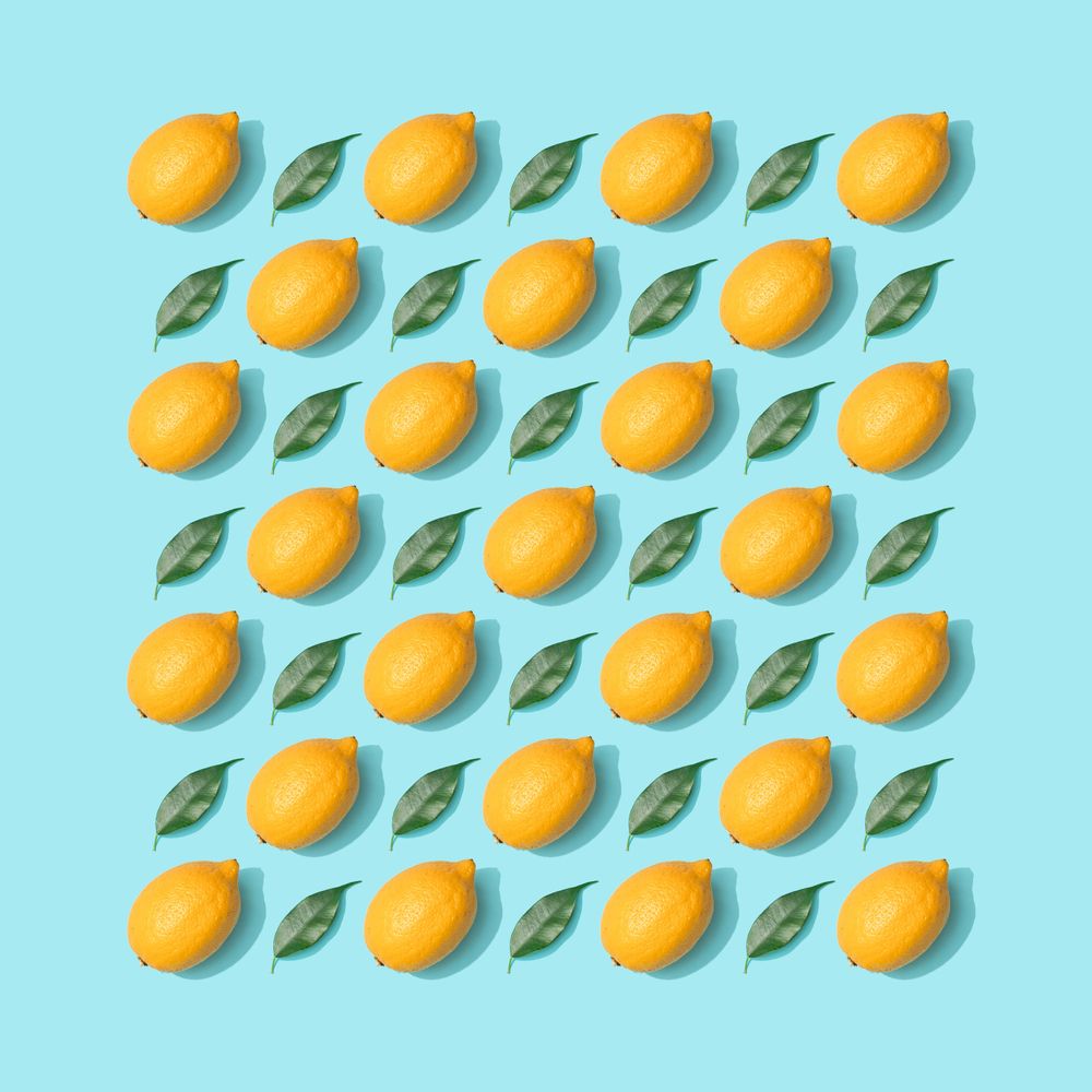 Lemons and leaves pattern on pastel blue background
