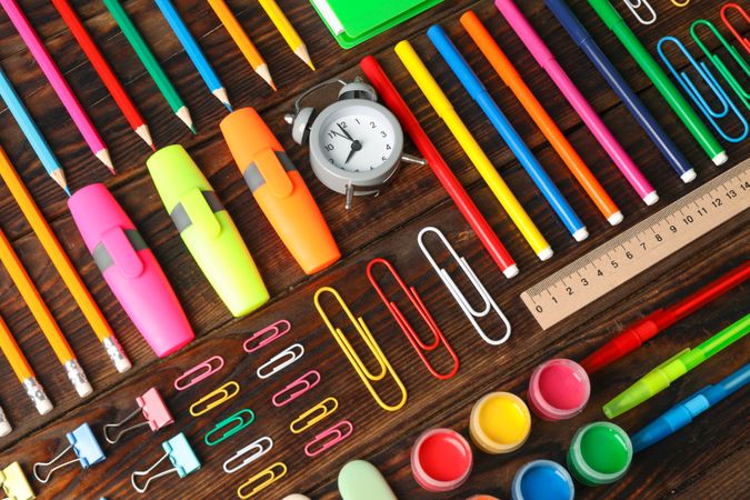 Flat lay composition with school supplies on wooden background