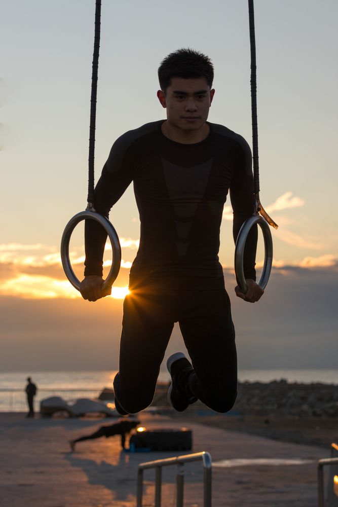 Sportsman training on gymnastic rings