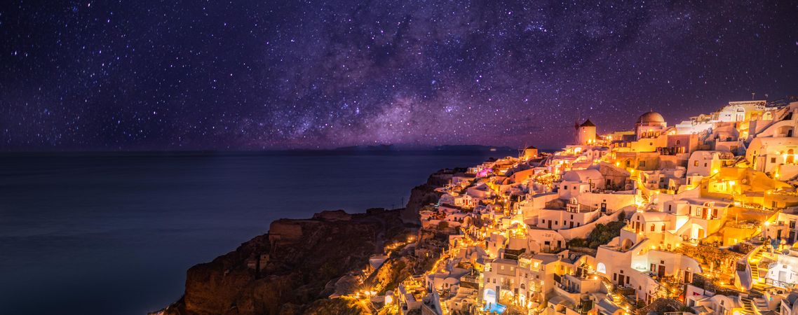 Santorini at night with starry sky, wide