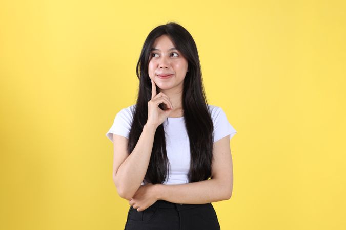 Asian Indonesian Young Woman with Long Hair Doing Thinking Gesture