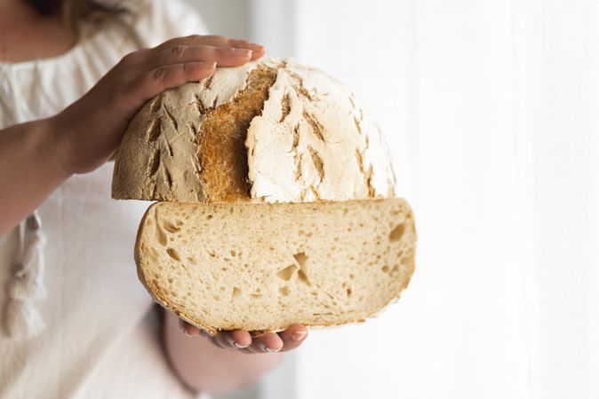 Sliced sourdough bread held in hands