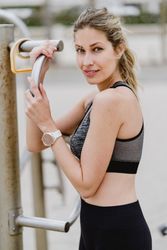 Sportswoman resting after workout in a sandy beach