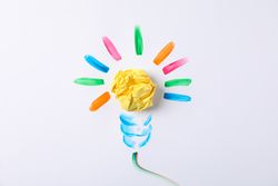Drawn light bulb and paper ball on blank background, space for text