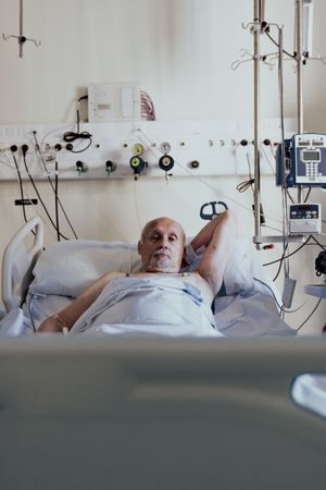 Older man admitted to a hospital room.