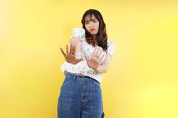 Asian Woman with a Hand Raised in No Gesture