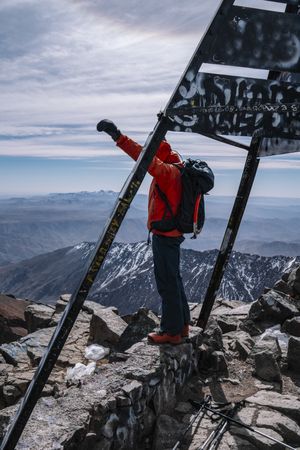 Elated tourist celebrating reaching mountain top