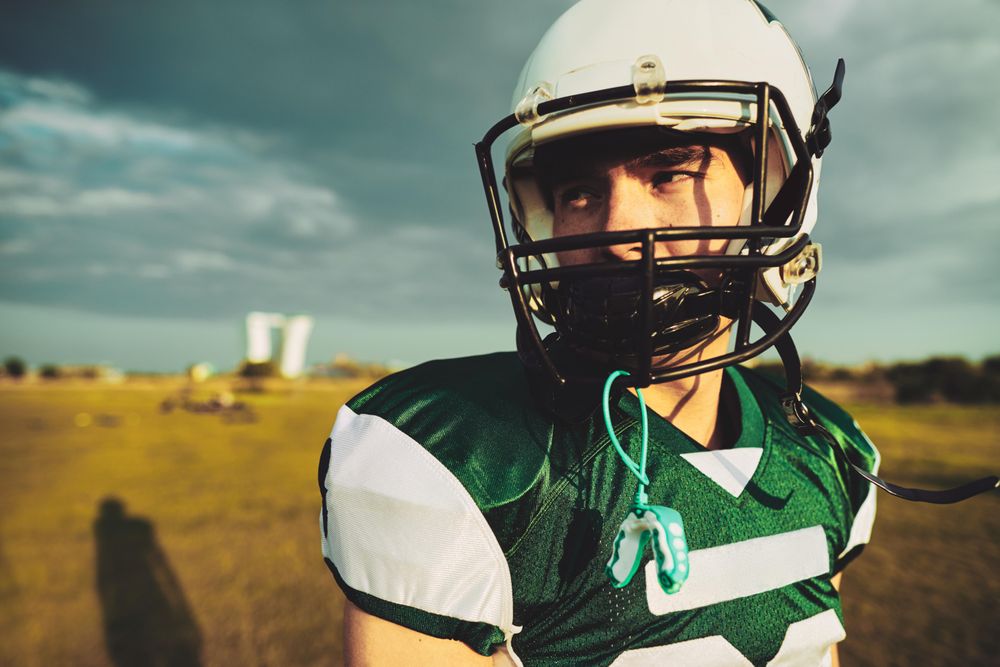 Portrait of man in football jersey and helmet