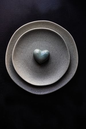 Table setting with grey plates and heart