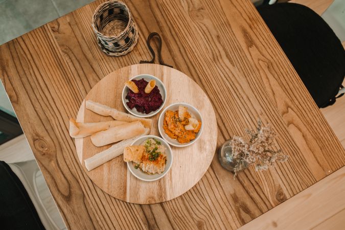Different tasty sauces on round wooden stand