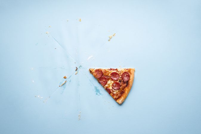 Last sliced of pizza pepperoni on blue background