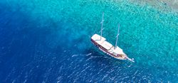 Aerial shot of boat in tropical waters, wide