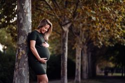 Pregnant woman standing in garden