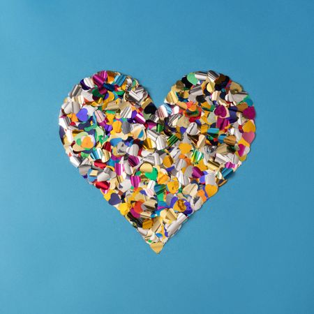 Confetti heart shape cut out of blue paper