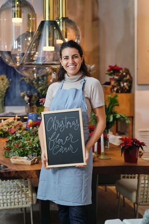 Happy Woman with Christmas Board