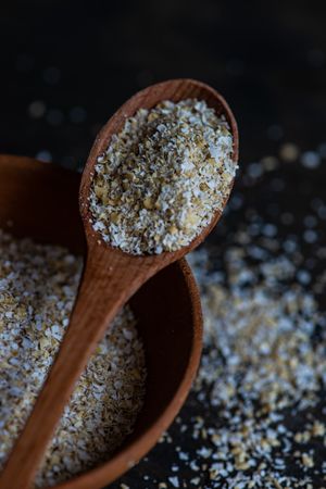 Close up of wooden spoon with ground oats