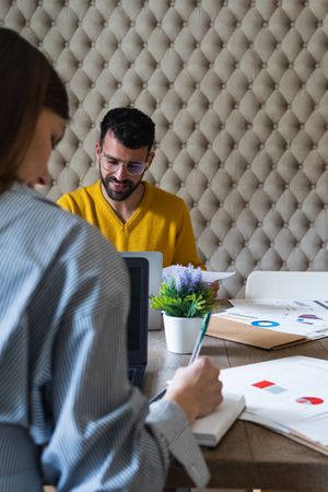 Focused colleagues working on laptops in coworking space