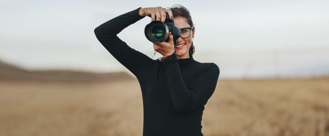 Portrait of female photographer using her digital camera