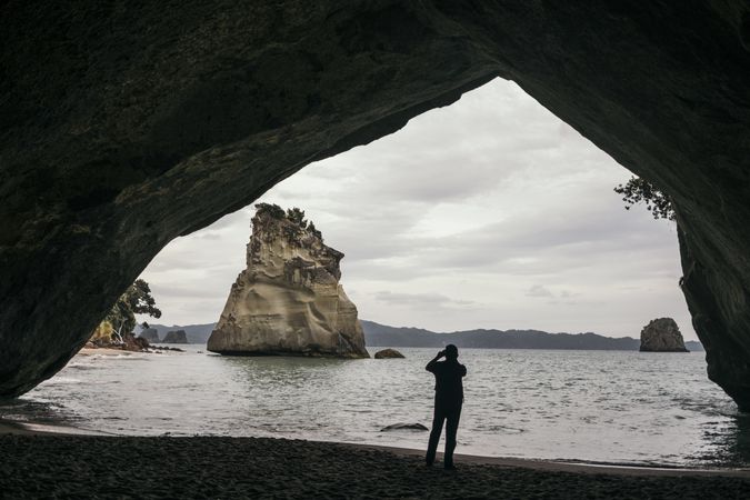 Traveler walking at tranquil sandy beach