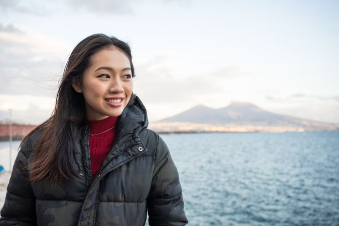 Woman on vacation in warm wear on seashore