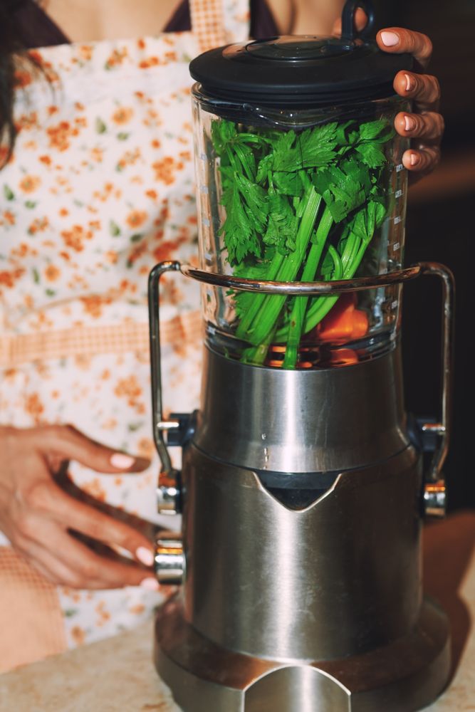 woman using electric mixer to prepare vegetarian