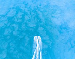 Aerial view of a jet ski racing across the water.