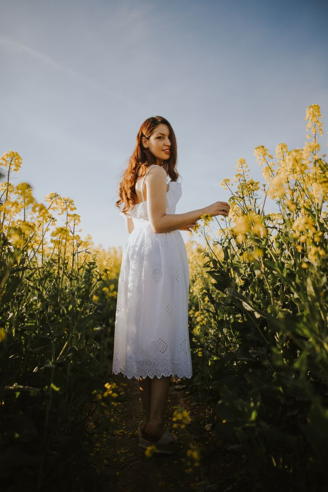 Woman with flowers in field