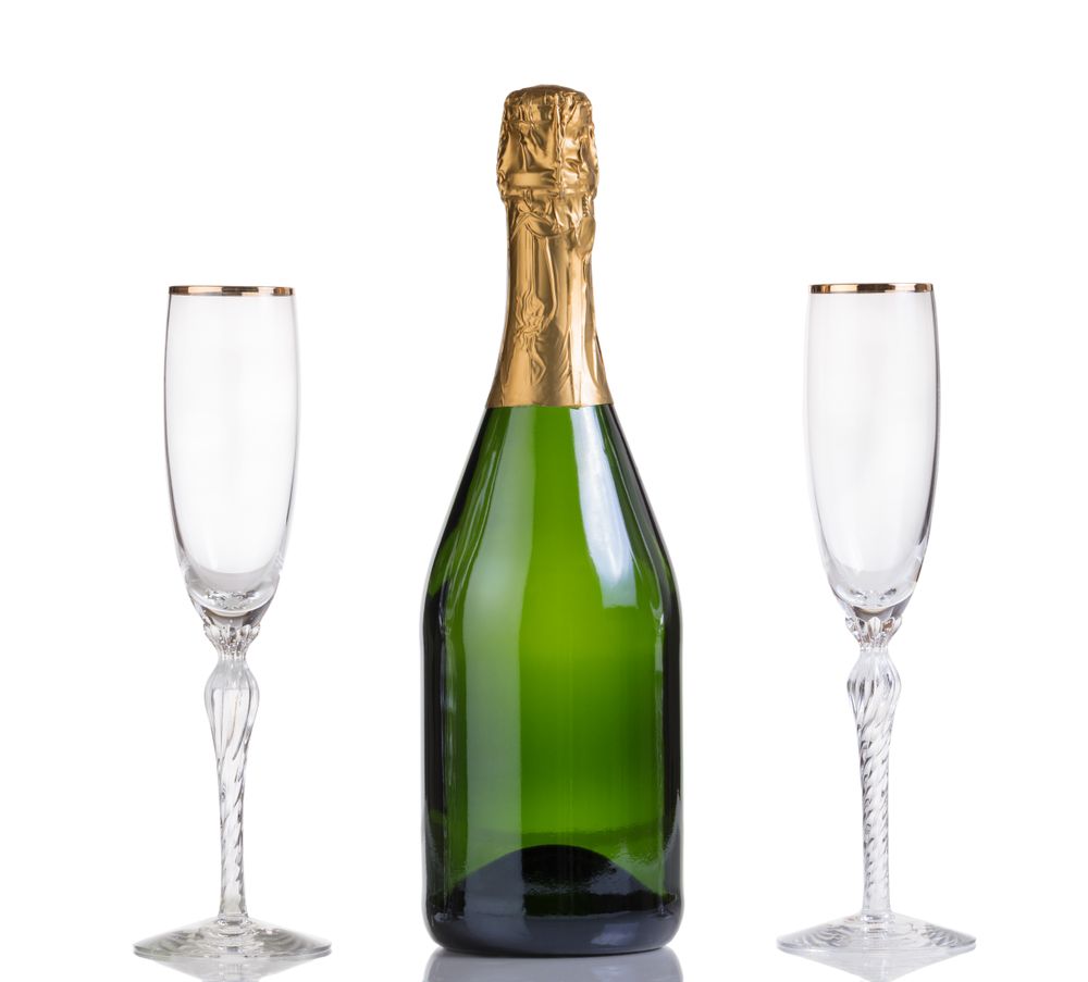 Unopened bottle of champagne and drinking glasses