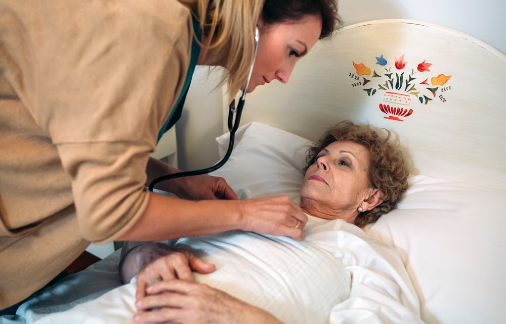 Caregiver auscultating woman
