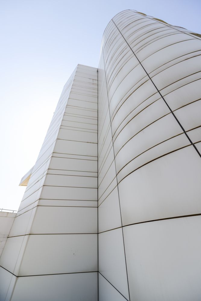 Looking up at windowless facade of modern building