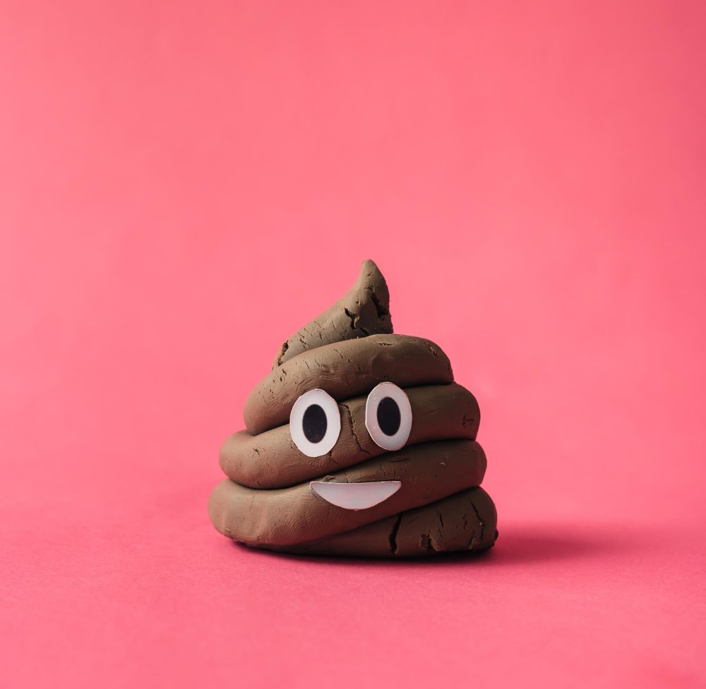 Poop emoticon on pink background