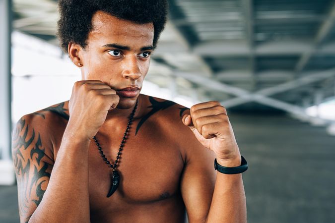 Close up of athletic Black male  boxing during training
