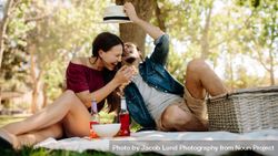 Couple enjoying on picnic at park bxnLX5