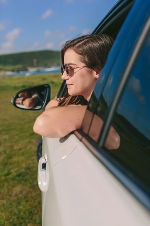 Woman leaning on window of the car
