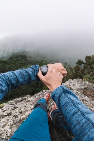 Man's hand with watch in the mountains