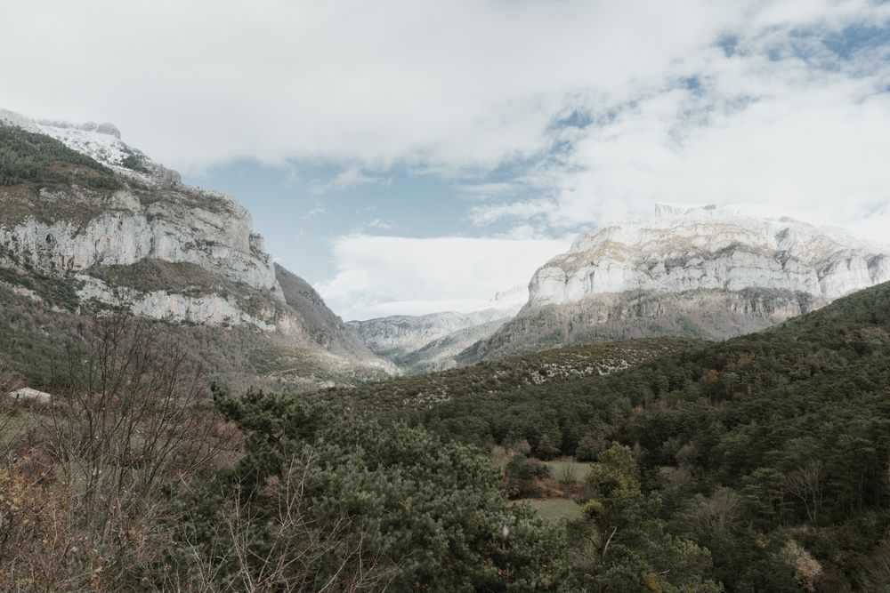Wonderful valley with trees and high hills in cloudy weather