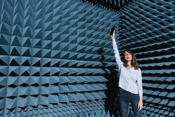 Woman in sound room holding smartphone
