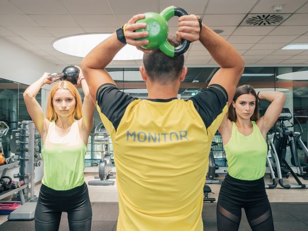 Athletes squatting with kettlebells
