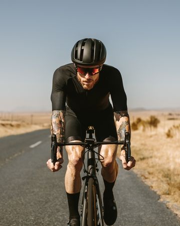 Professional athlete cycling on highway