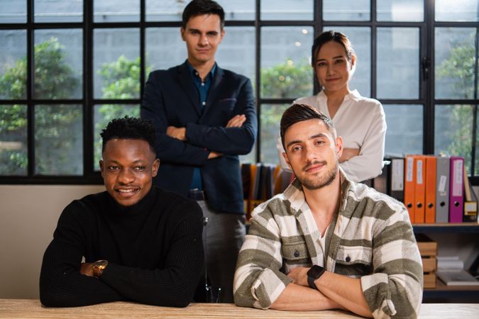Multi-ethnic group of creative professional in office with arms crossed