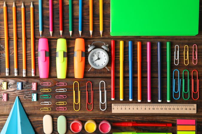 Flat lay composition with school supplies on wooden background