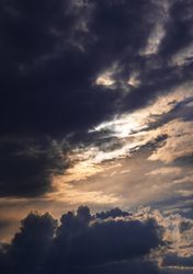 Vertical orientation of grey clouds in the dusk sky