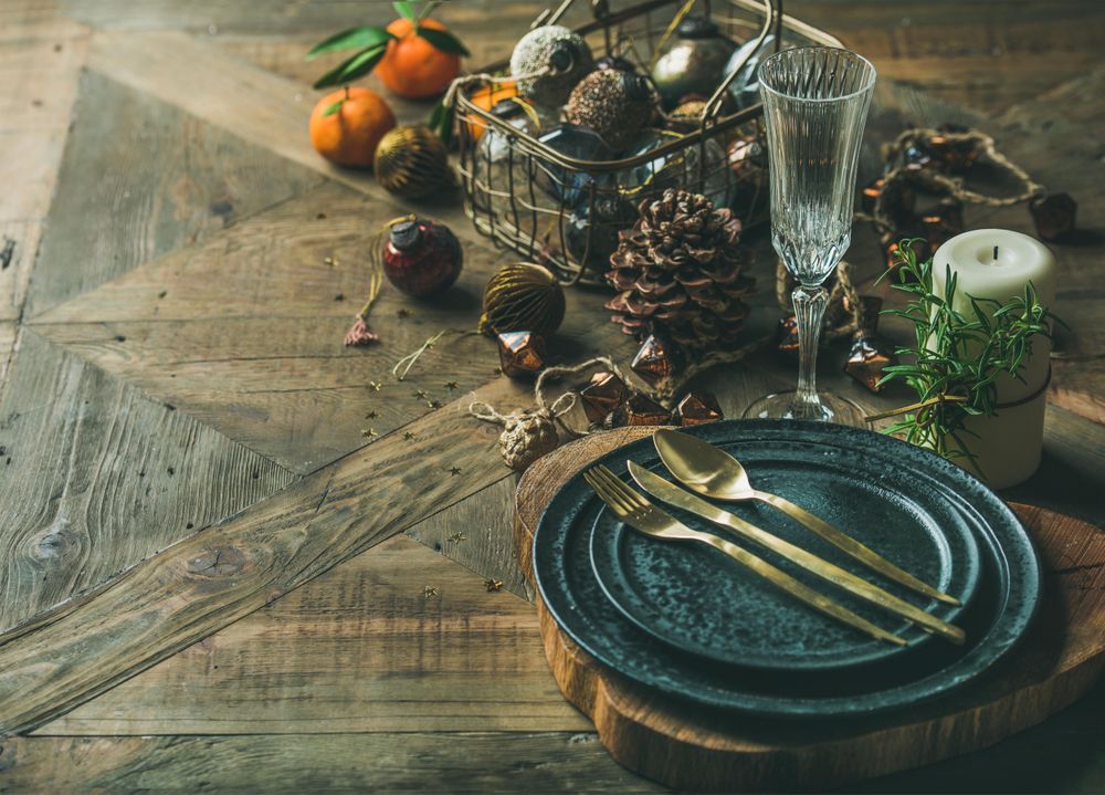 Top view of table setting with crystal flute of Champagne, pinecone, and candle, with copy space