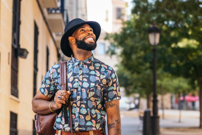 Stylish Black man walking on the city street