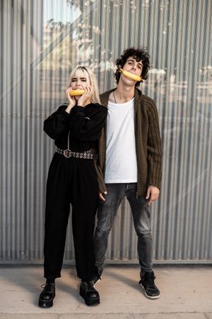Couple covering faces and feelings under fake mask of joy
