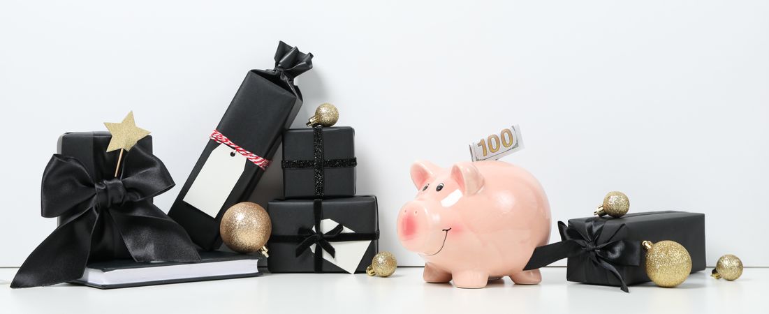 Piggy bank, balls and gift boxes on light background