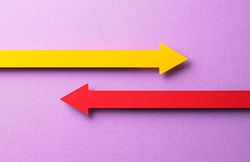 Two paper arrows going in opposite directions