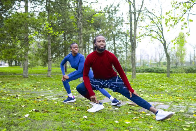 Friends preparing with stretches ahead of their training session.